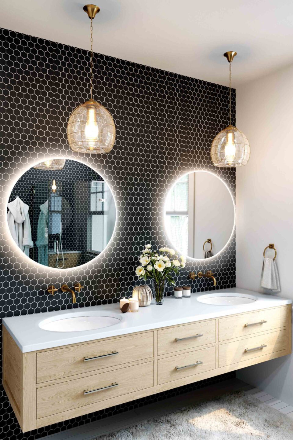 dwa lustra okragle podswietlane w lazience nad umywalkami na scianie z czarnych plytek