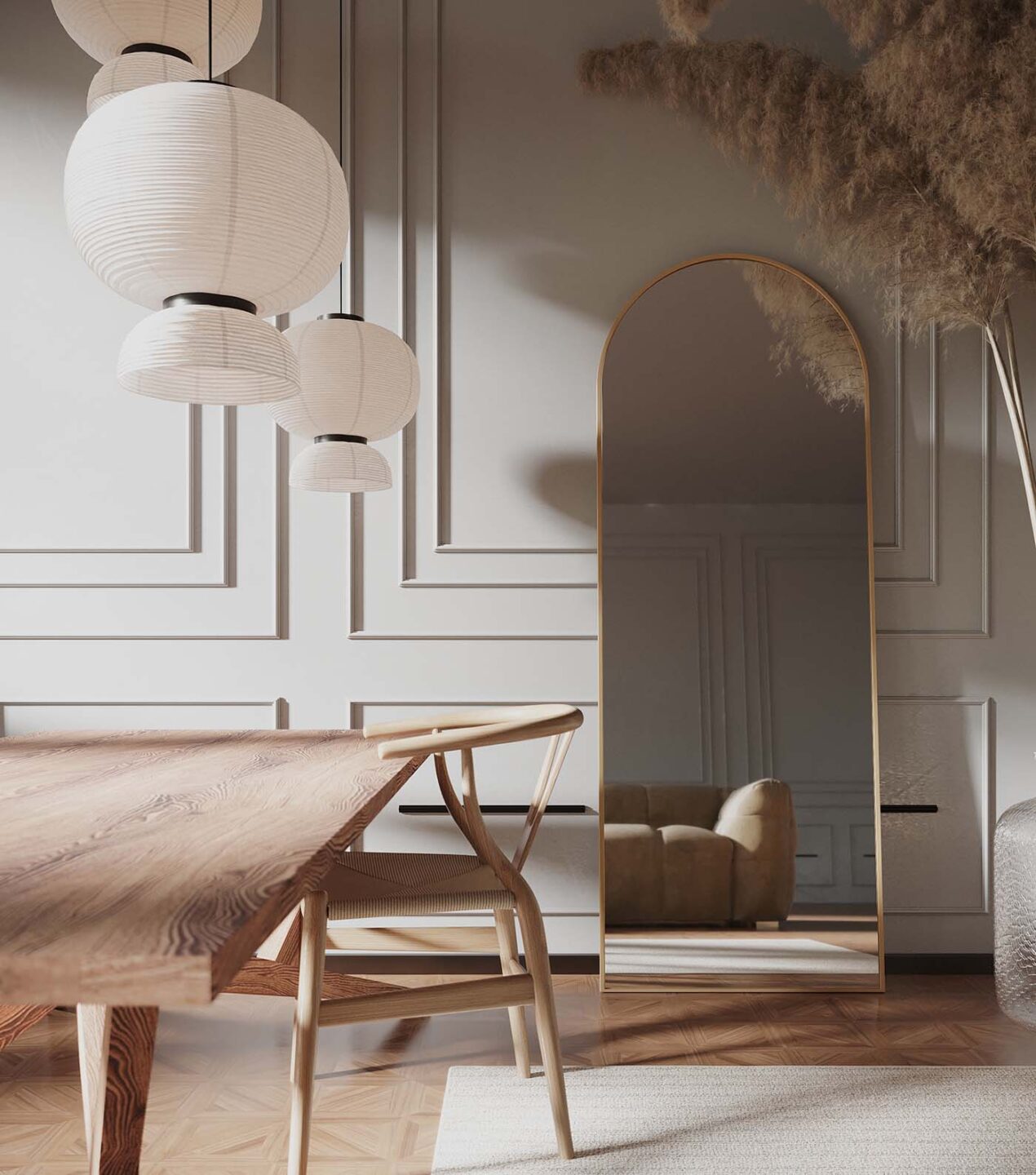 duże lustro arkadowe w złotej ramie oparte o ścianę ze sztukaterią w beżowym salonie