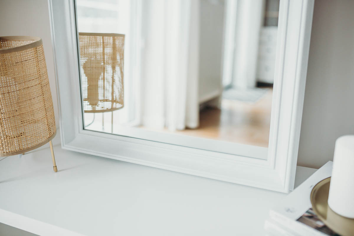 Lustro w białej ramie stojące na blacie