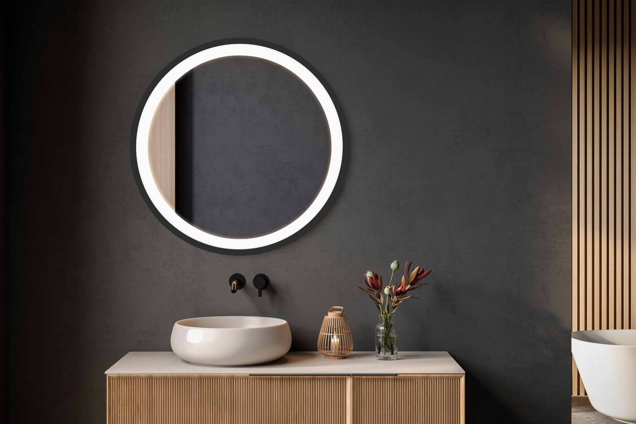 lustro okragle ring do makijazu w czarnej ramie w ciemnej lazience nad bezowa umywalka