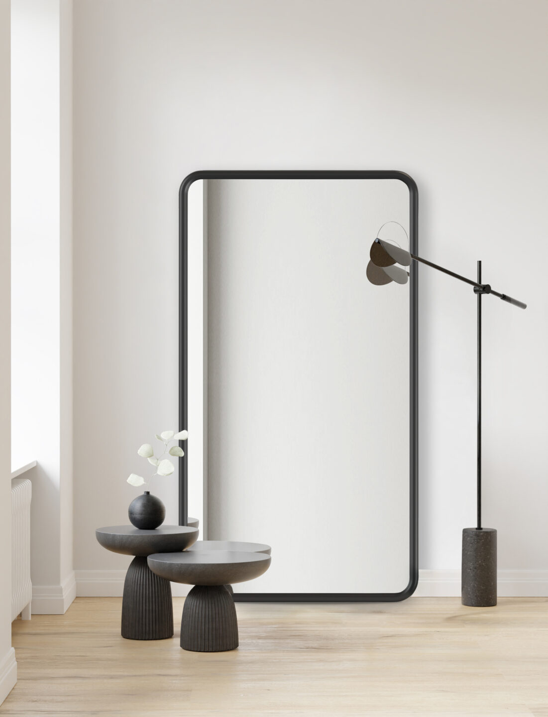 duże lustro w czarnej ramie z zaokrąglonymi rogami