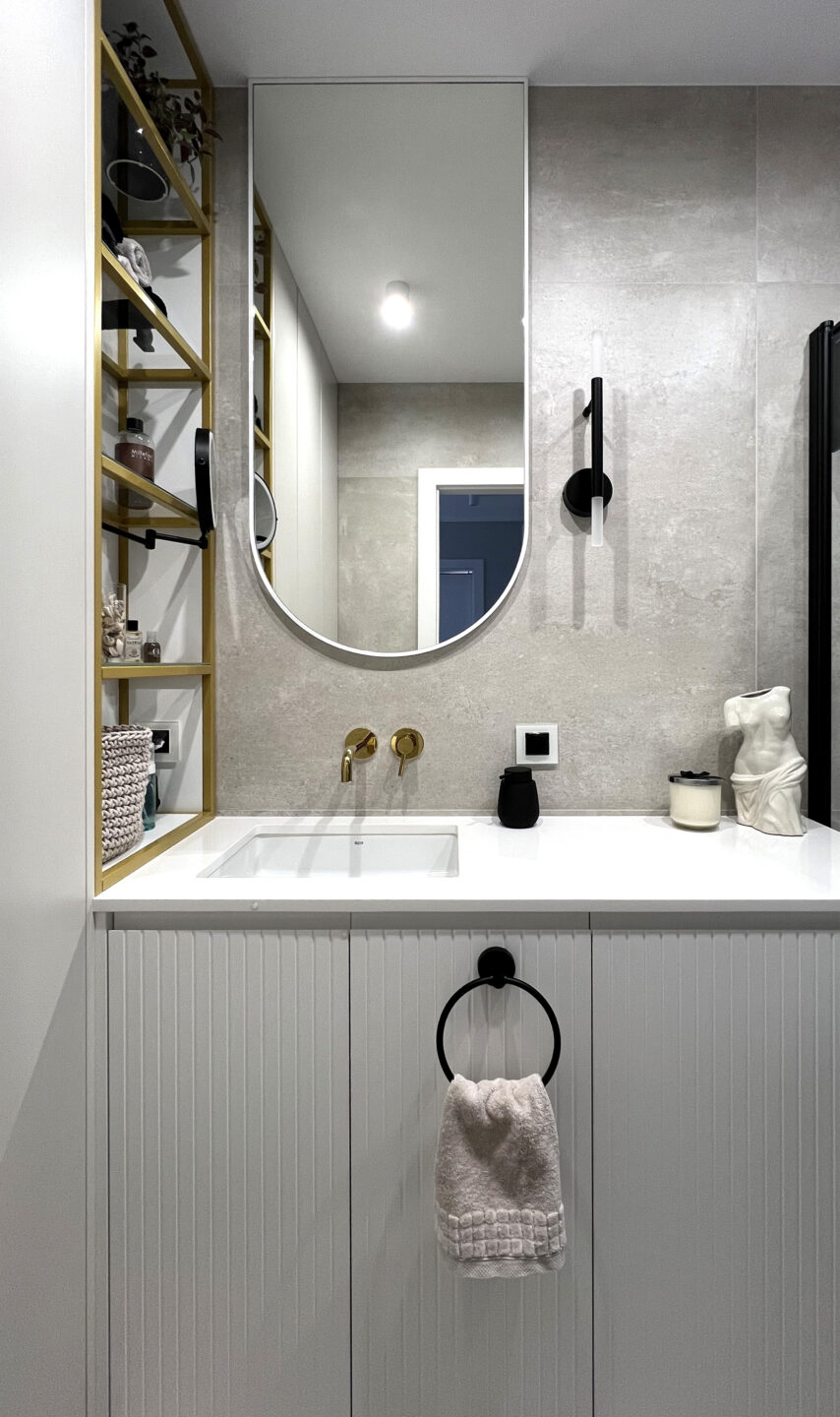 lustro arkadowe w białej ramie w łazience powieszone łukiem do dołu