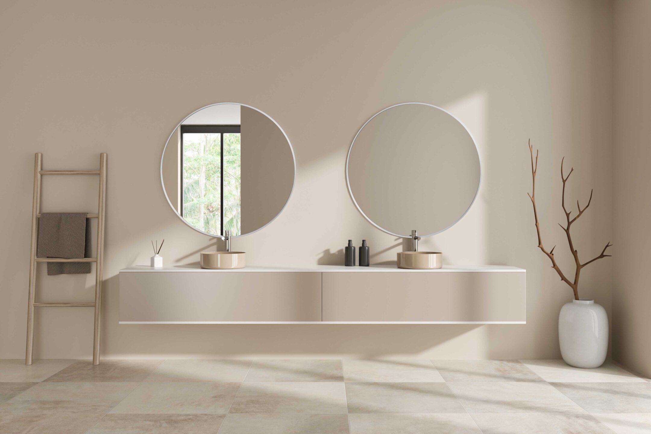 dwa okrągłe lustra w srebrnej ramie w beżowej łazience japandi